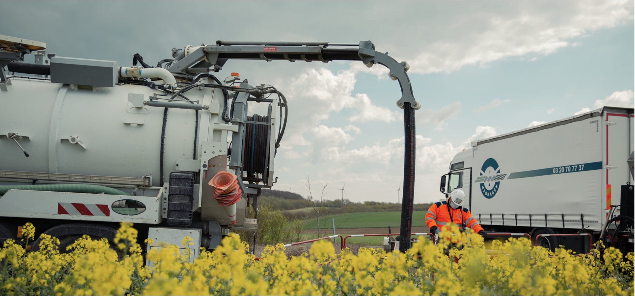 Camion hydrocureur STPA en intervention sur un chantier entouré de colza